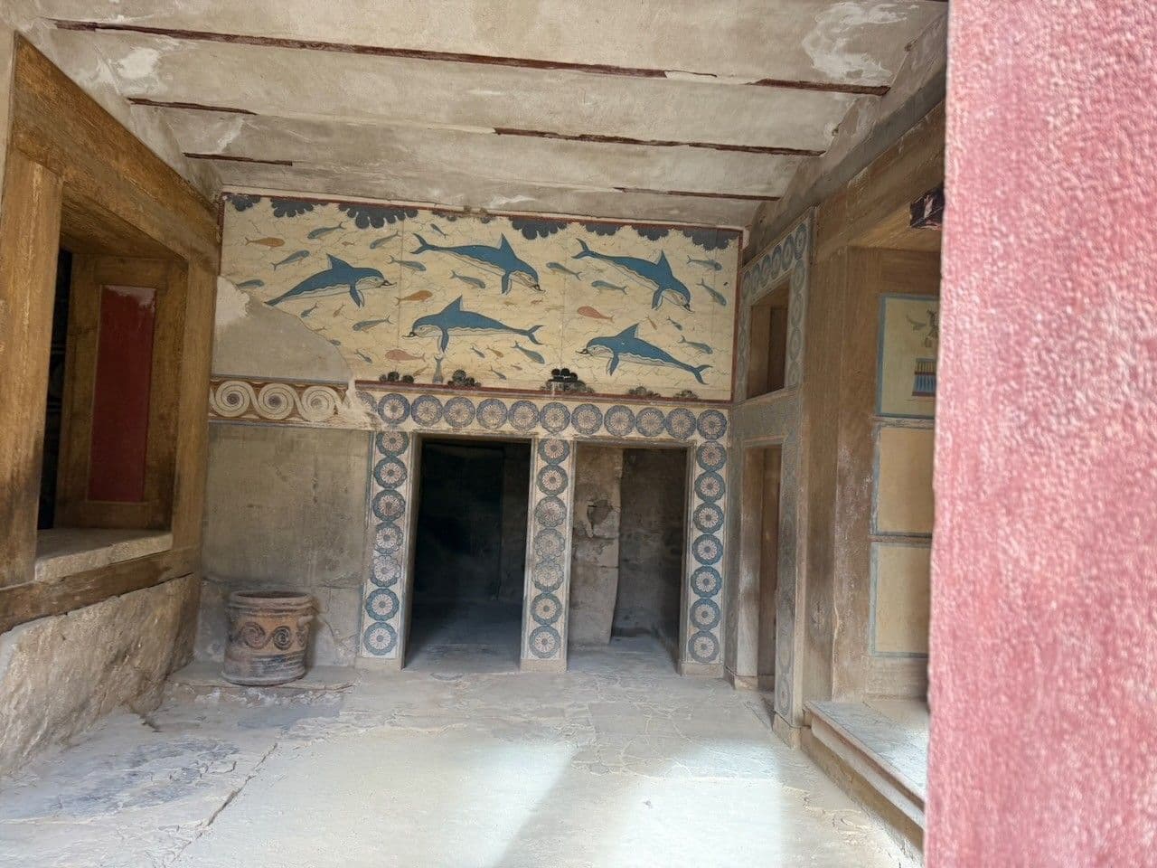 The dolphin fresco in the Queen's Megaron at Knossos, blue dolphins and small fish on a cream wall