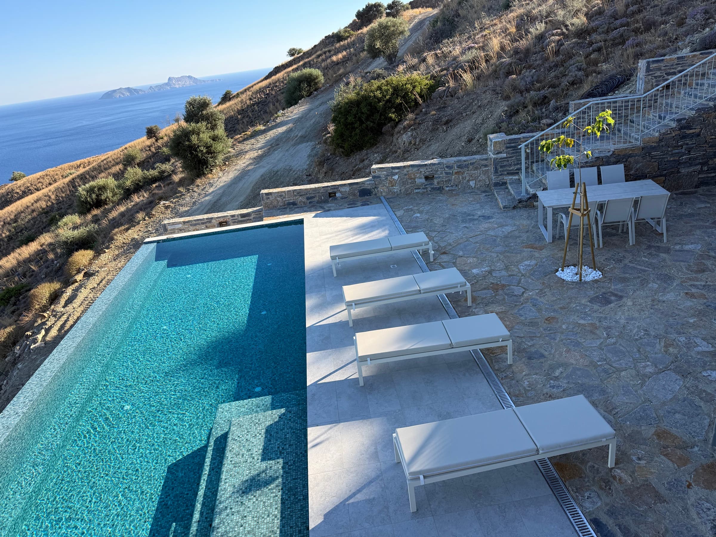 Sunbeds and umbrellas beside the infinity pool